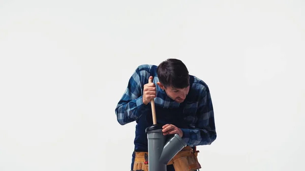 Plumber cleaning plastic pipe with plunger isolated on white — Stock Photo