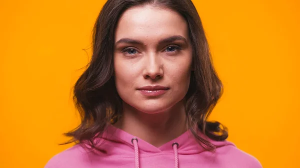 Young confident woman looking at camera isolated on yellow — Stock Photo