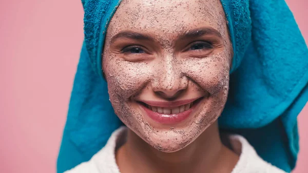 Close up view of cheerful woman with scrub on face isolated on pink — Stock Photo