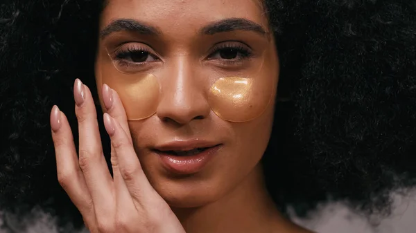 Nahaufnahme einer hübschen Afroamerikanerin beim Auftragen von Augenklappen — Stockfoto