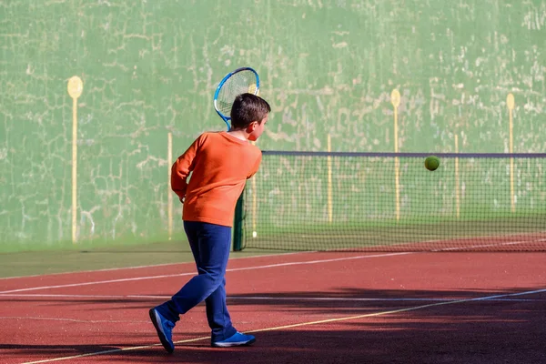 Mladý chlapec hraje tenis — Stock fotografie