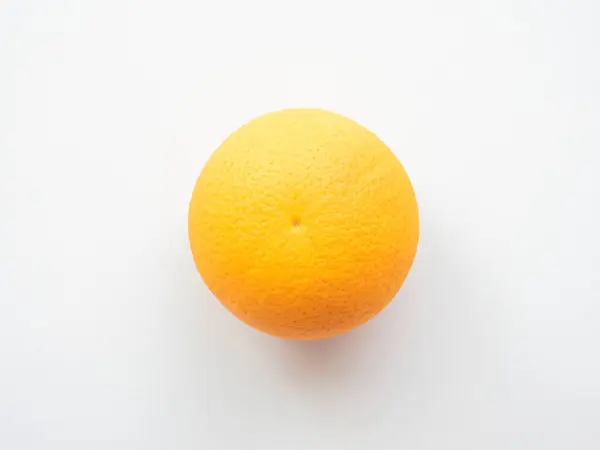 Ripe orange on a light gray surface — Stock Photo, Image