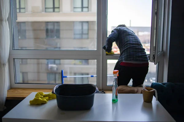 Man Cleaning Window At Home. A Worker Washes Windows In Office. Window Cleaning.