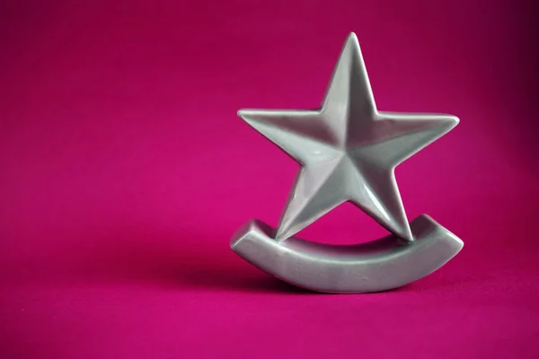 Christmas Five Pointed Golden Star On Pink Background. Christmas Decoration.