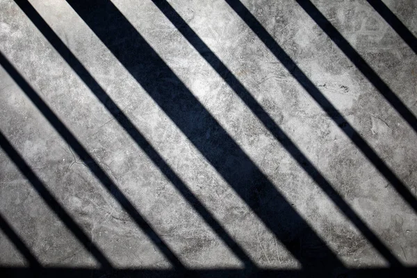Abstract Shadows On The Wall. From the railing cast a shadow on the plain concrete floor.