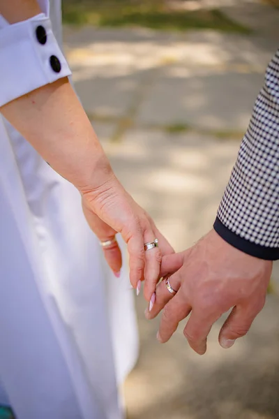 Hands Of A Newly-Married Couple With Wedding Rings