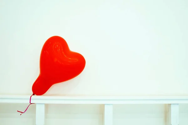 Heart Shaped Balloon On A White Background, Copy Space.