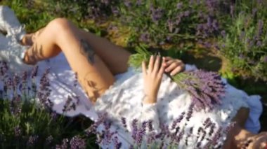 Yaz günü lavanta tarlasında dinlenen güzel bir kadın.