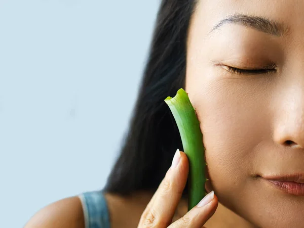 Aloe Vera Takes Care Of My Skin! Beautiful Asian Woman Posing With A Leaf Of Aloe