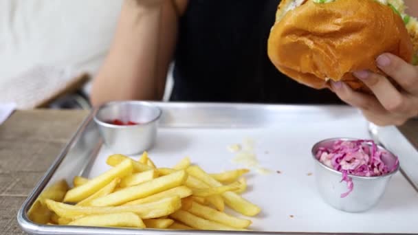 Красивая Азиатская Женщина Ест Гамбургер Ресторане Наслаждаясь Вкусный Сочный Гамбургер — стоковое видео