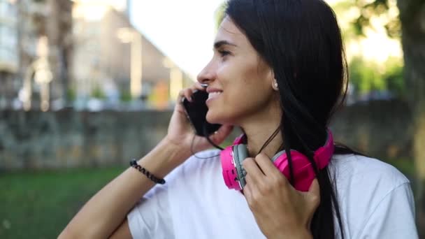 Telepon Bicara Wanita Muda Dengan Headphone Berbicara Mobile Phone Duduk — Stok Video