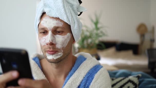 Young Bearded Metrosexual Man Applying Charcoal Clay Facial Mask Looking — Stock Video