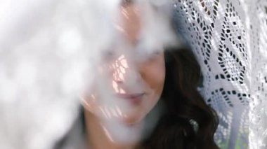 Kafkasyalı güzel bir gelinin portresi. Kadın gözlerini kaldırır ve kameraya bakar. Mutluluğun tadını çıkarıyor. Düğün günü..