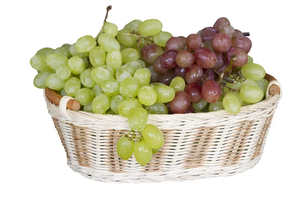Green and red grapes in a wicker basket. — Stock Photo, Image