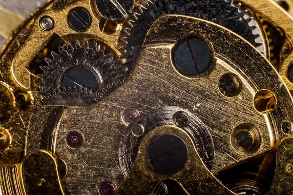 Achtergrond met metalen tandwielen een uurwerk. macro — Stockfoto