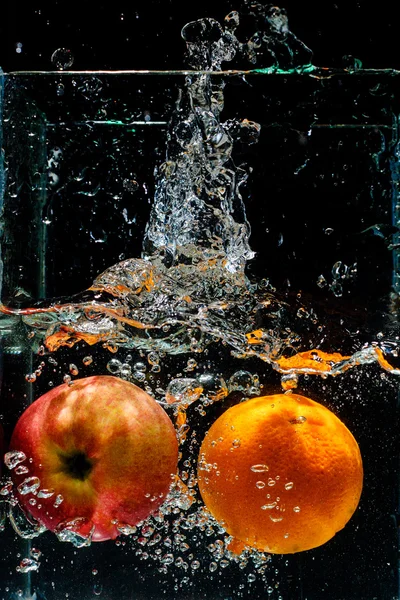 Orange dropped in fish tank filled with water — Stock Photo, Image
