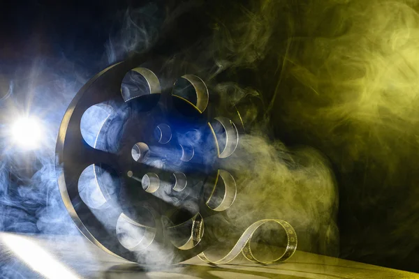 Reel van film retro in de rook blauw en geel — Stockfoto