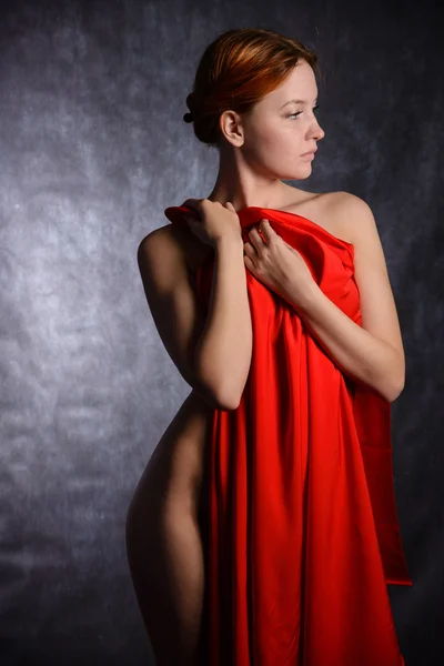 Beautiful woman with red tissue around her waist — Stock Photo, Image