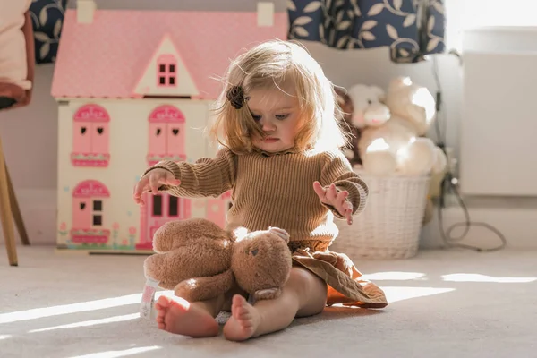 Cute Blond Toddler Girl Light Brown Sweater Sitting Floor Playing — Stock Photo, Image