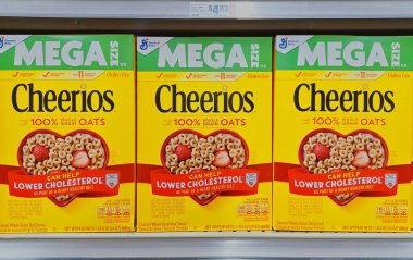 Houston, Texas USA 10-08-2025: Cheerios cereal boxes mega size lower cholesterol on supermarket shelf.