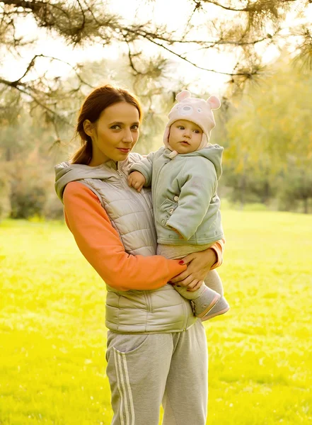 Jonge moeder met haar kinderen in het najaar park — Stockfoto