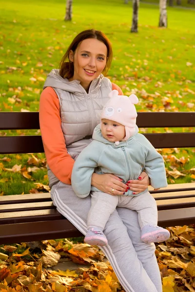 Madre joven con sus hijos en el parque otoño —  Fotos de Stock