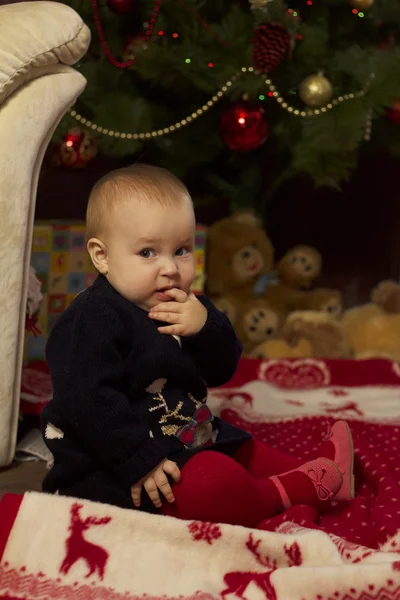 Baby girl with gifts under Christmas tree — Stock Photo, Image