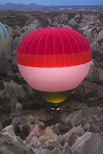 Hot air balloon flying over rock landscape at Cappadocia Turkey — Stock Photo, Image