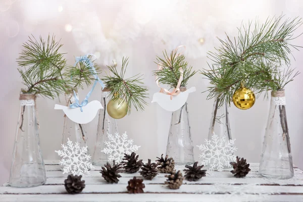 Christmas decorations on a branch of tree in glass vases — Stock Photo, Image