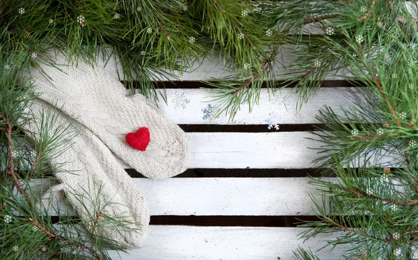 Christmas mitten decor and snow fir tree over wooden background with copy space — Stock Photo, Image