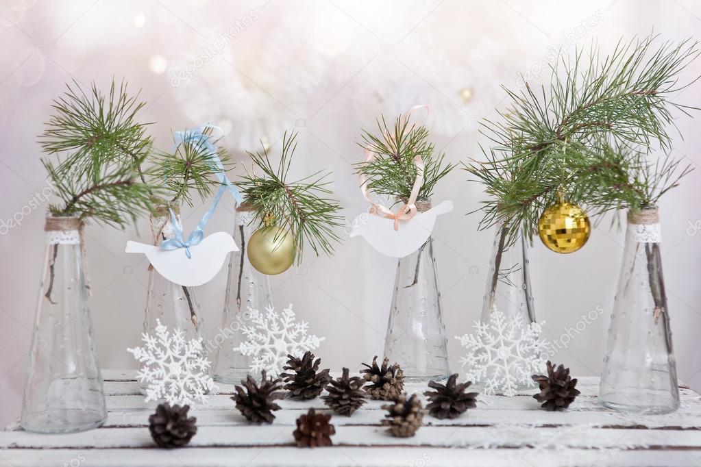 Christmas decorations on a branch of tree in glass vases