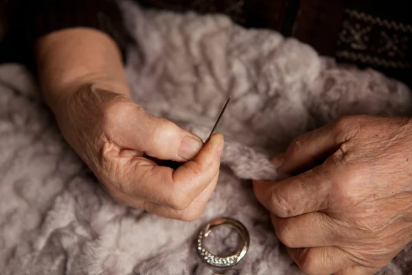 Hands of an elderly woman for sewing — Stock Photo, Image