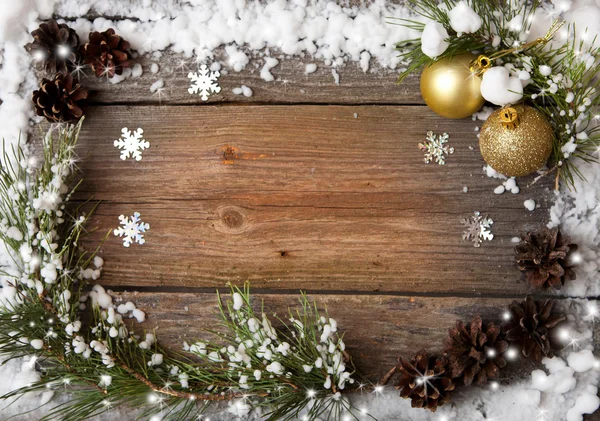 Snow fir tree with cones and Christmas decorations over wooden background, copy space — Stock Photo, Image