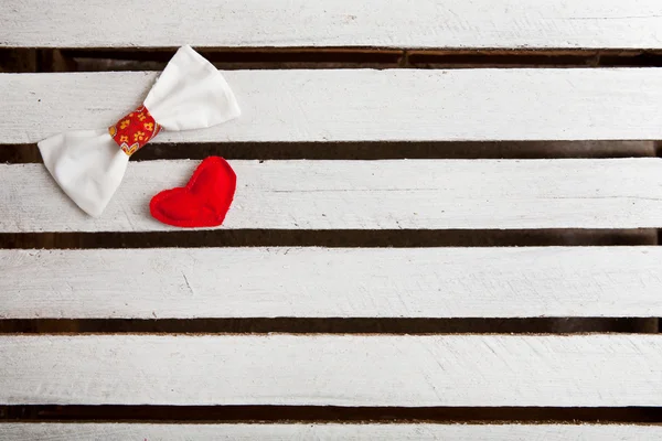 Love hearts with bow tie on wooden planks, copy space — Stock Photo, Image