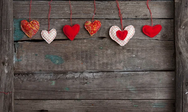 Lot of hearts on wooden background — Stock Photo, Image
