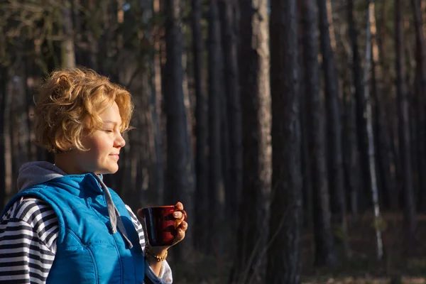 Vrouw drinken koffie of thee buiten in de zon licht genieten van — Stockfoto