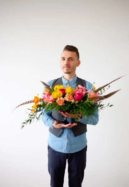 Young man with bouquet of flowers in his hands. — Stock Photo, Image
