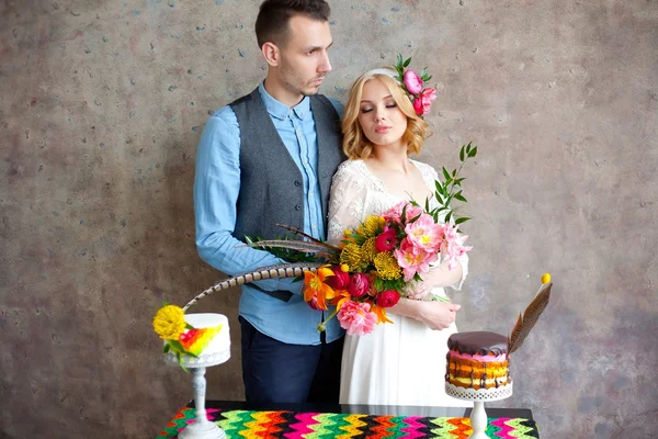 Young wedding couple against texture wall — Stock Photo, Image