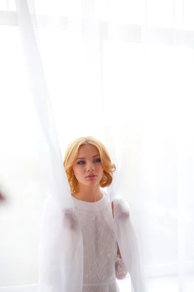 Sexy girl on a background of white curtains — Stock Photo, Image