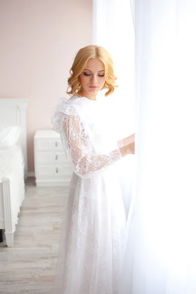 Sexy girl on a background of white curtains — Stock Photo, Image