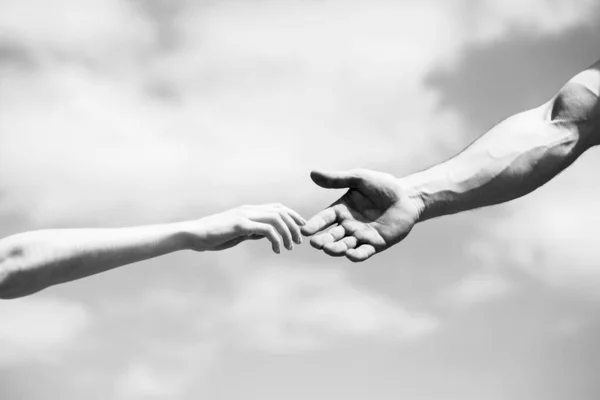 Giving a helping hand. Lending a helping hand. Solidarity, compassion, and charity, rescue. Black and white — 스톡 사진