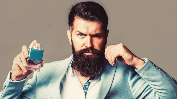 Bearded male prefers expensive fragrance smell. Man perfume, fragrance. Masculine perfume. Male fragrance and perfumery, cosmetics