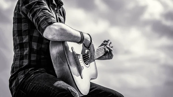 Mans hands playing acoustic guitar, close up. Acoustic guitars playing. Music concept. Black and white — Stock Photo, Image