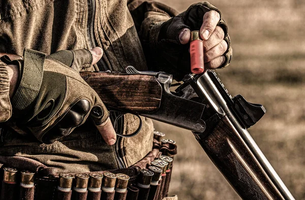 Male hunter in ready to hunt. Closeup. Hunter man. Hunting period. Male with a gun, rifle. Man is charging a hunting rifle. Process of hunting during hunting season — Stock Photo, Image