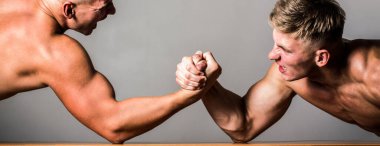 Arm wrestling. Two men arm wrestling. Rivalry, closeup of male arm wrestling