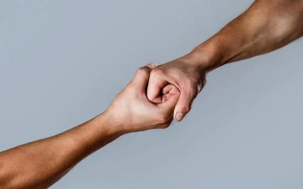 Two hands, helping arm of a friend, teamwork. Helping hand outstretched, isolated arm, salvation. Close up help hand. Helping hand concept and international day of peace, support — Stock Photo, Image