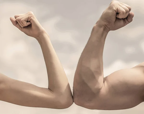 Muscular arm vs weak hand. Vs, fight hard. Competition, strength comparison. Rivalry concept. Hand, man arm fist Close-up. Rivalry, vs, challenge, strength comparison. Sporty man and woman — Stock Photo, Image