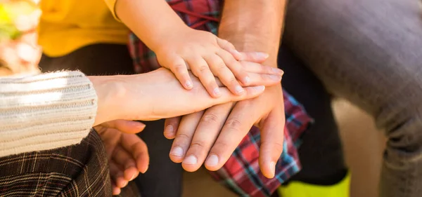 Concept of unity, support, protection, happiness. Child hand closeup into parents. Hands of father, mother, keep hand little baby. Parents hold the baby hands. Closeup of baby hand into parents hands