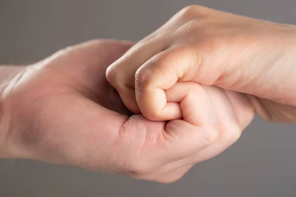 Male and child hands connected each other together and forever. Woman and kid hands connect with each other. Friendly handshake, friends greeting. Rescue, helping hand. Man help hands, protection