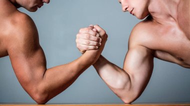 Muscular hand. Clasped arm wrestling. Two men arm wrestling. Rivalry, closeup of male arm wrestling. Two hands. Muscular men measuring forces, arms. Hand wrestling, compete. Hands or arms of man